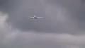 Plane flies on cloudy day HD Footage