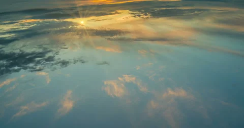 The plane flies in the cumulus clouds of the day sky, a beautiful time lapse Stock Footage 110889005