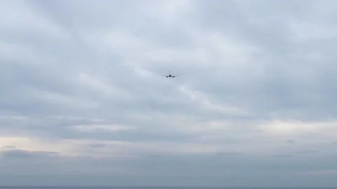 The plane flies into the distance in the sky Stock Footage 236773526