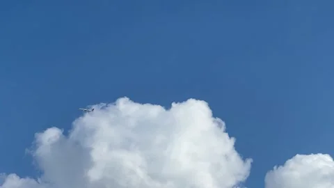 The plane flies in front of clouds Stock Footage 182154330