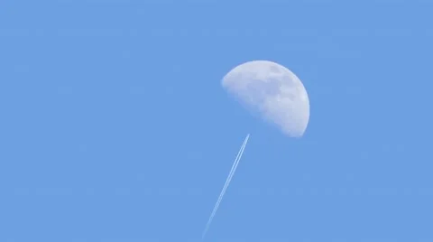 Plane Flies In Front Of Moon In Daytime Stock Footage
