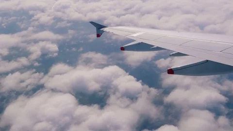 Plane flies highly over Earth and clouds Stock Footage 75805940