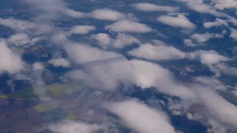 Plane flies highly over Earth and clouds Stock Footage 75832881