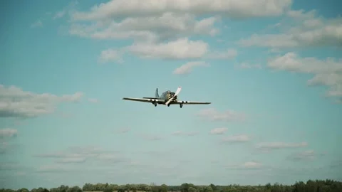 The plane flies low above the ground Stock Footage 147716013