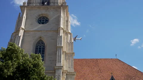 The plane flies at low altitude over the city, with the landing gear down, Stock Footage 277667385