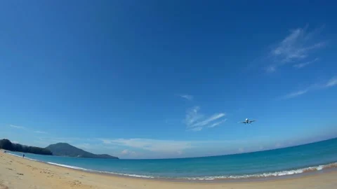The plane flies low over the deserted beach Stock Footage 159116825