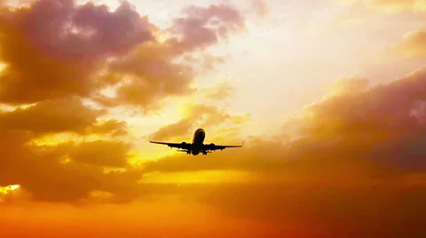 Plane flies low over the ground at sunset Video stock 37118167