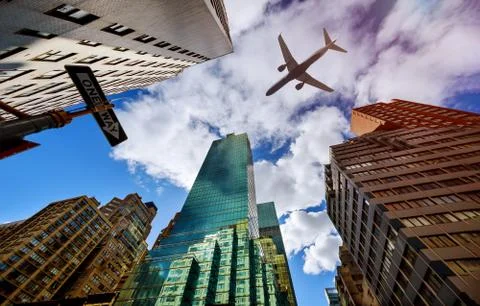 Plane flies low over the New York City Manhattan Skyline USA Stock Photos