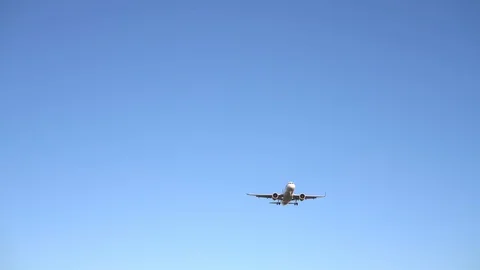 The plane flies over the camera against the blue sky. the plane is landing Video stock 127133806