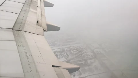 The plane flies over the city Stock Footage 98654033