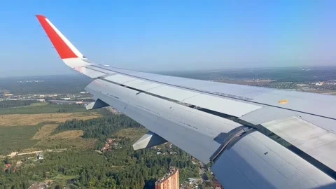 The plane flies over the city, preparing to land on the runway Stock Footage 305592138