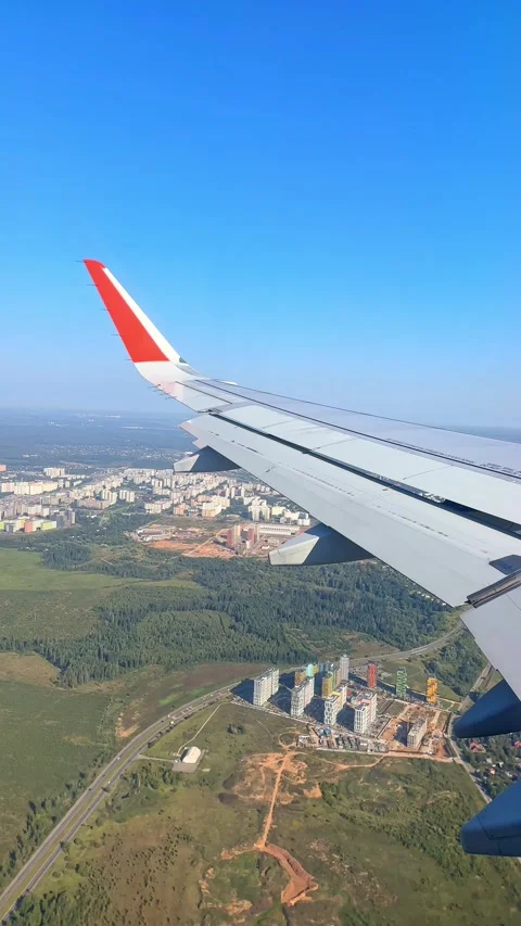 The plane flies over the city, preparing to land on the runway Stock Footage 305601714
