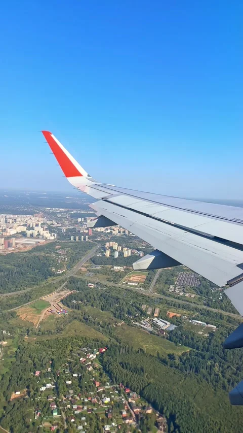 The plane flies over the city, preparing to land on the runway Stock Footage 305602936