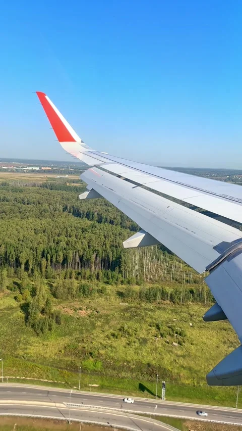 The plane flies over the city, preparing to land on the runway Stock Footage 305603231
