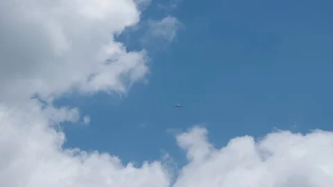 Plane flies over head in front of clouds, 4K Stock Footage 111329467