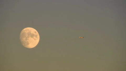 Plane Flies Over The Moon Stock Footage 138596429