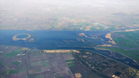 The plane flies over Netherlands on approaching the Amsterdam Stock-Footage 74476587