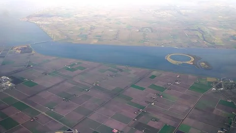 The plane flies over Netherlands on approaching the Amsterdam Stock-Footage 74478432