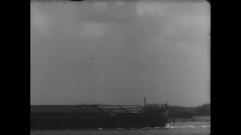 Plane flies over river, surrendered German troops chat Stock Footage 103378798