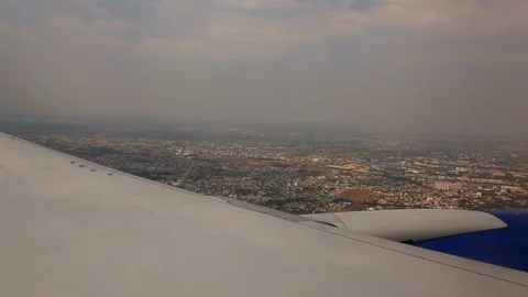 The plane flies over the roofs Stock Footage 116860008