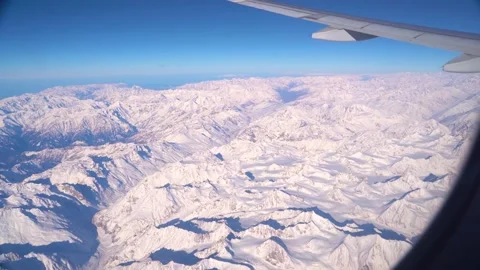 The plane flies over the snowy mountain peaks of the Alps, Leh, India. Stock Footage 145963708