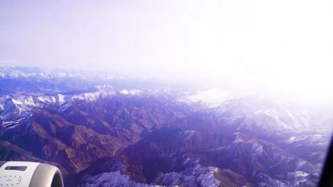 The plane flies over the snowy mountain peaks of the Alps, Leh, India. 動画素材 145964290