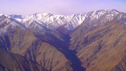 The plane flies over the snowy mountain peaks of the Alps, Leh, India. Stock Footage 145964889