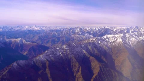The plane flies over the snowy mountain peaks of the Alps, Leh, India. 動画素材 145964972