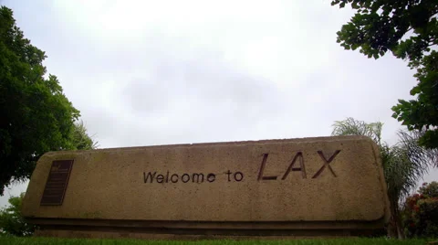 Plane flies over "Welcome to LAX" sign Stock Footage 52228236