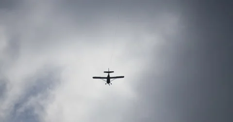 Plane Flies Overhead Towing Advertisement  動画素材 56190265
