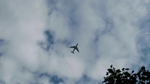 Plane flies in the sky against the background of textured clouds Stock Footage 141984597