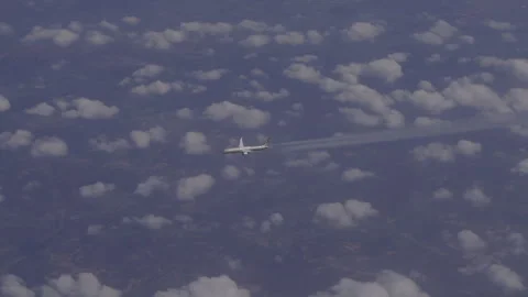 The plane flies in the sky with clouds. Overall plan. Stock Footage 256017675