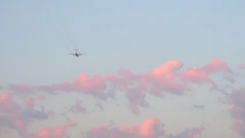 The plane flies in the sky at sunset. Stock Footage 89780594