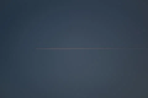 Plane flies in the sky at sunset Photos
