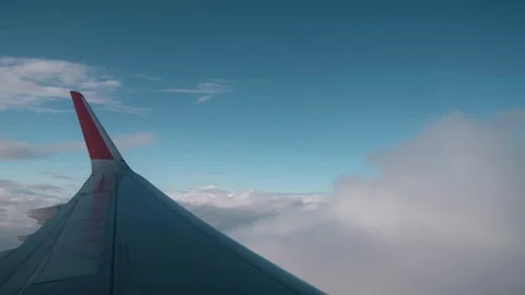 The plane flies through the clouds. The camera shoots from the aluminator Video stock 252202600