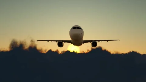 The plane flies through the clouds into the distance Stock Footage 318565615