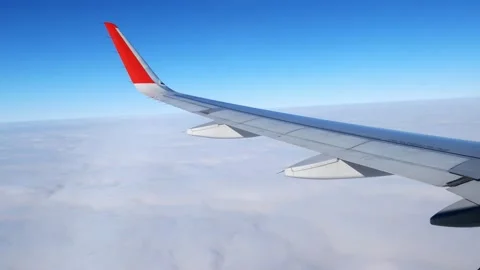 The plane flies through the cumulus clouds. Descent from blue skies into Stock Footage 166314346