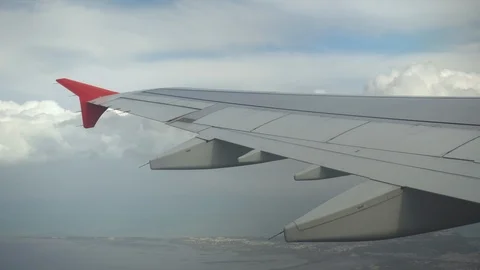 The plane flies in white clouds. View from the airplane window to the wing Video stock 120686876