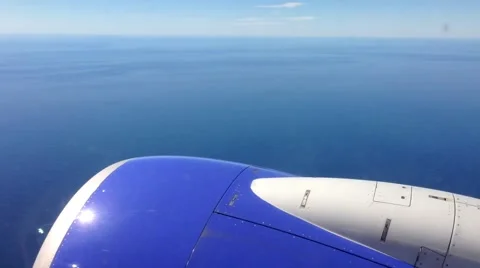 Plane flight over ocean with engine outside (passenger POV) Stock Footage 47790893