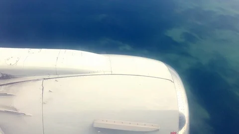 Plane flight over sea scape clouds sunny day Stock Footage 116008080
