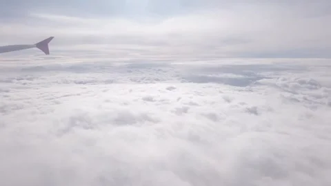 Plane flight over white cloud and sunbeams at sky Stock Footage 308820969