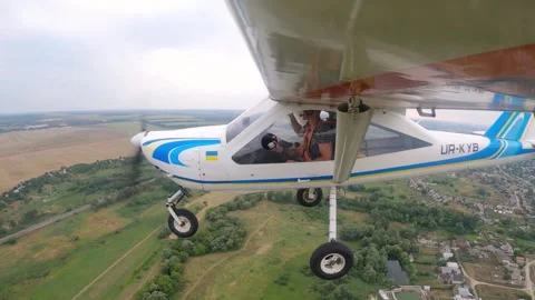 Plane in flight showcasing aerial view of landscape, capturing the dynamic Stock Footage 324799297