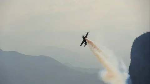 Plane fly along cliff. Light-engine aircraf with smoke. Aerobatics. Airshow. 스톡 동영상 145551644