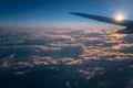 The plane fly in the evening sky on the background of beautiful clouds Photo