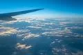 The plane fly in the sky on the background of beautiful clouds Photo