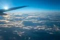 The plane fly in the sky with cloud on the background of bright sun Photo
