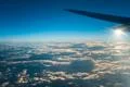 The plane fly in the sky with cloud on the background of bright sun Photo
