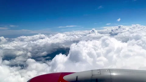 Plane flying above beautiful white clouds Stock Footage 266437008