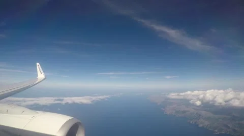 Plane flying above coast with cloudy sky Video stock 55211034