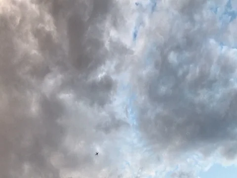 Plane Flying Across Rain Clouds Stock Footage 78013276